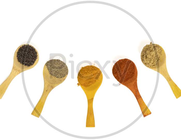 Indian Spicy Masala Powders In Wooden Spoon, White Background. Selective Focus