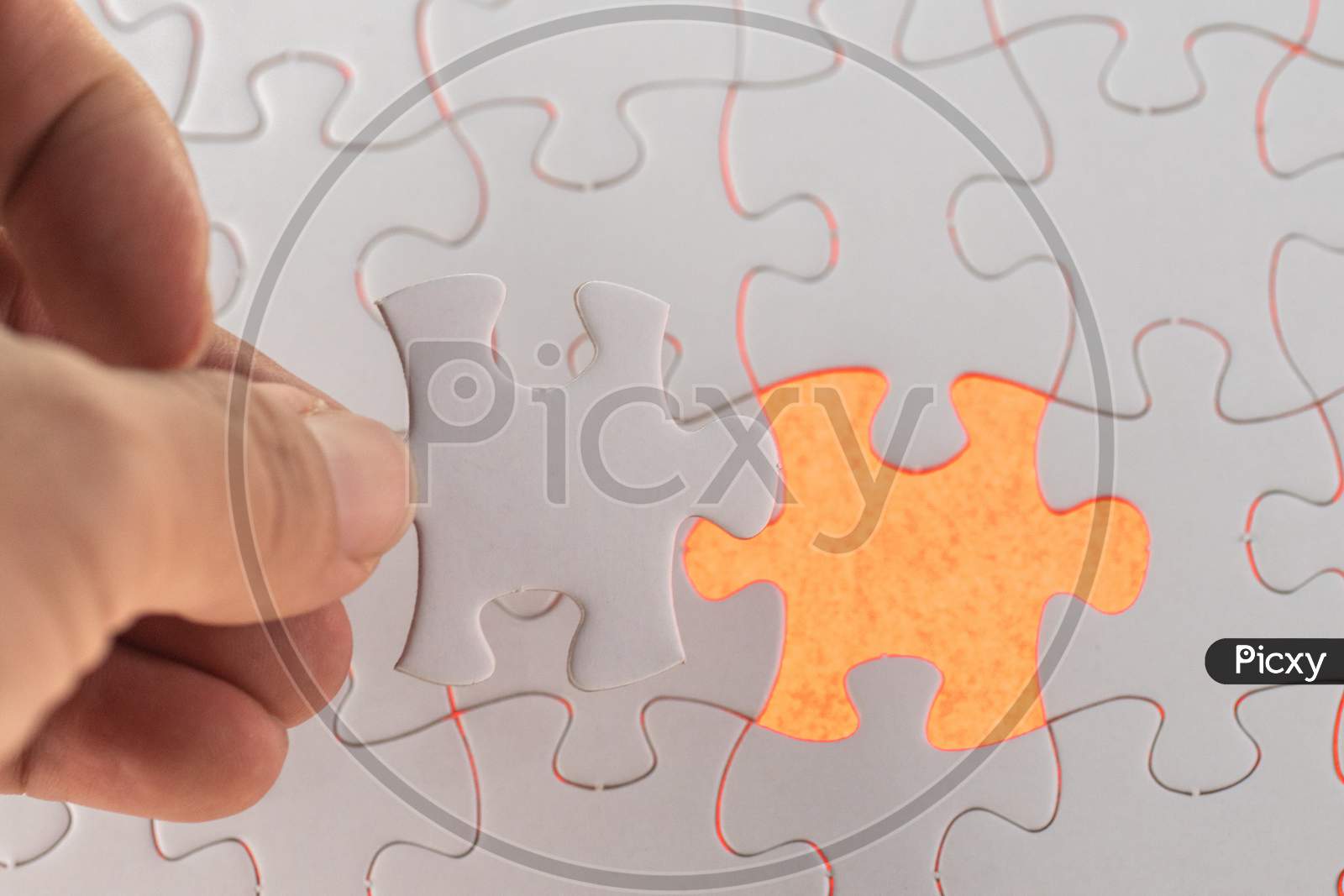 A Hand Hold The Missing Piece Of White Puzzle