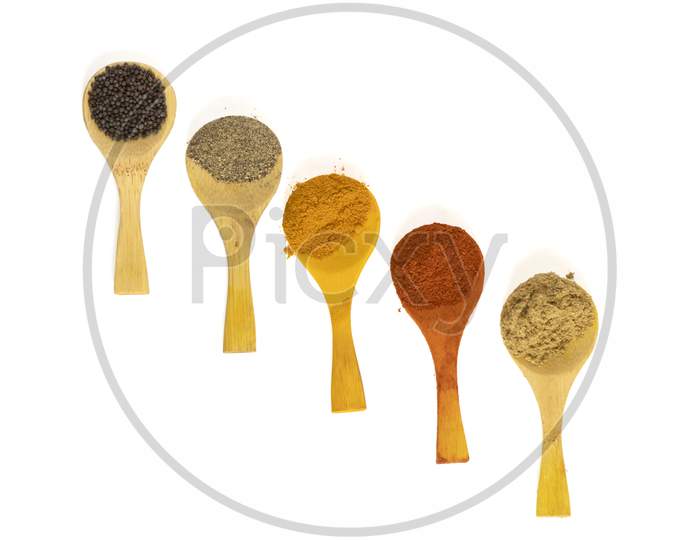 Indian Spicy Masala Powders In Wooden Spoon, White Background. Selective Focus