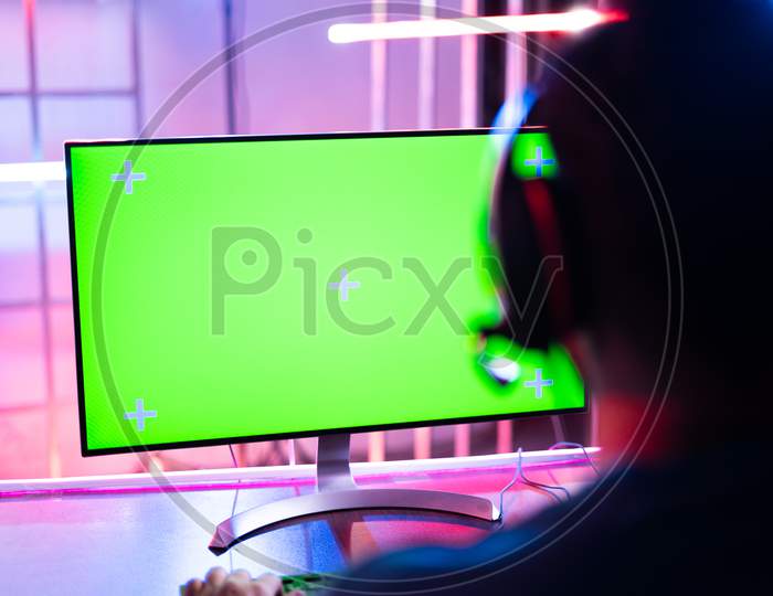 Shoulder Shot Of Professional Video Gamer Playing Video Game On Agreen Screen Computer Monitor - Concept Of Esports Tournment On Neon Light Background