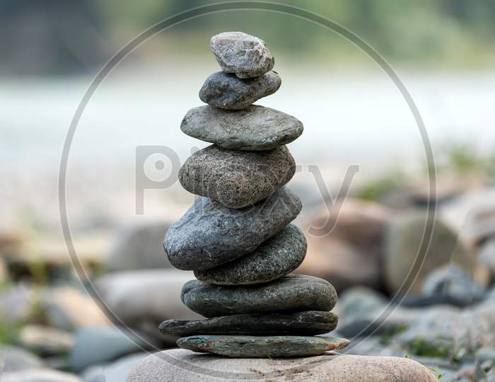 Pyramid Of Round Gray Stones On The Bank Of A Mountain River. Zen And Harmony Concept.Stone Tower