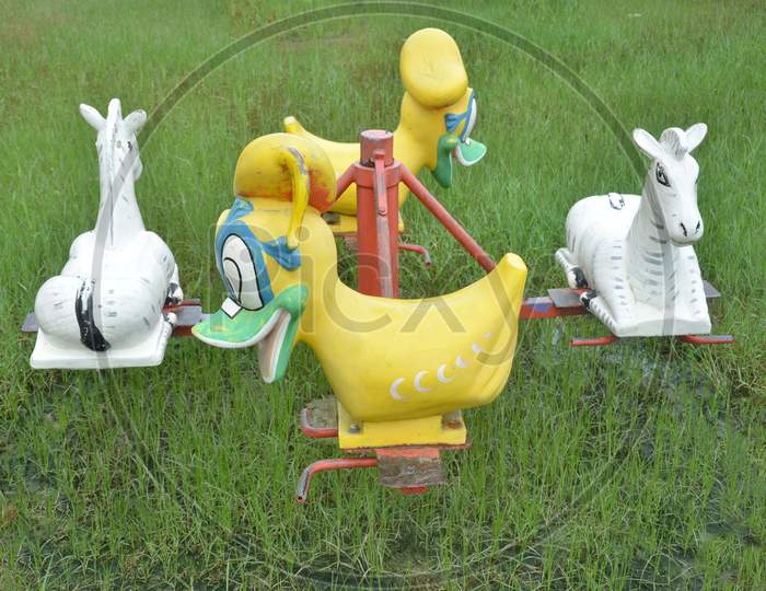 There are two duck puppets and two horse puppets used in a hammock. Hammock is uesd by children in the park.