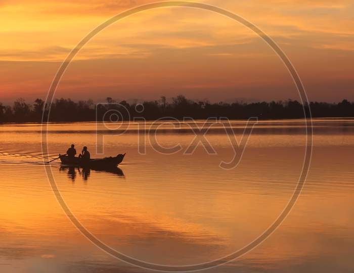 Two Fishermen friend returning after catching fish at beautiful dusk from river Sangu in Bandarban, Bangladesh