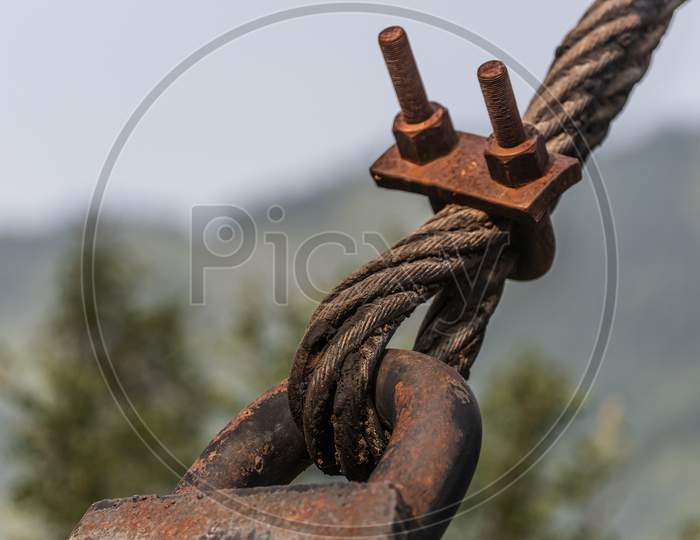 Close-Up Of Fastening The Metal Rope Of The Suspension Bridge To The Support