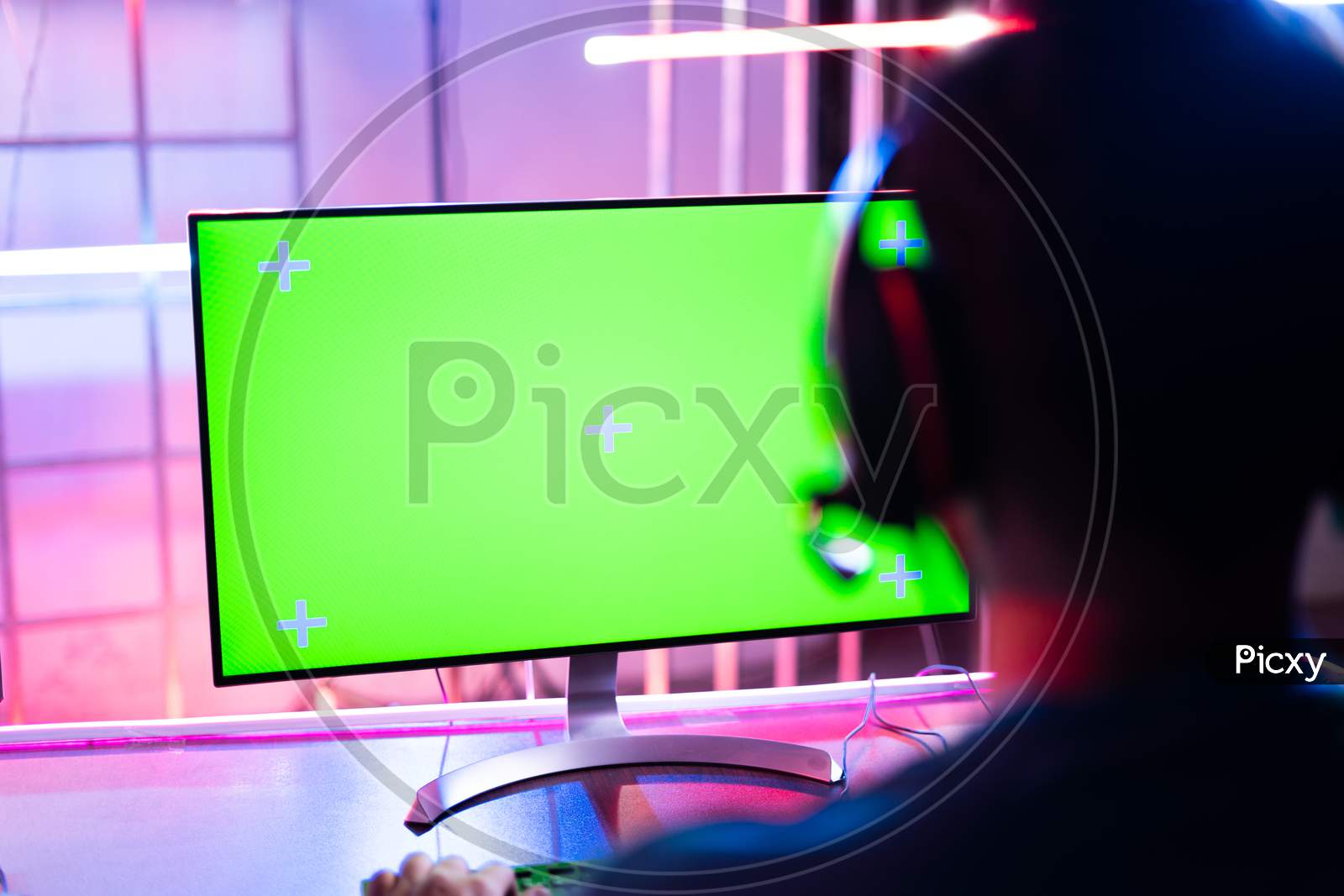 Shoulder Shot Of Professional Video Gamer Playing Video Game On Agreen Screen Computer Monitor - Concept Of Esports Tournment On Neon Light Background