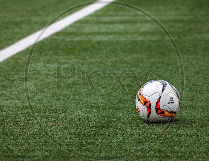 White Adidas Soccer Ball on Grass.