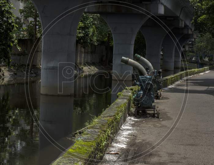 Two Motorized Pumps At Road Side Beside A Canal To Avoid Over Flow Due To Heavy Rain.