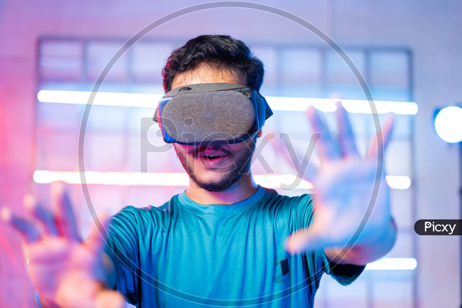Amazed Young Man First Time Experiencing Vr Or Virtual Reality Headset On Neon Light Background - Concept Of Futuristic And Modern Technology.