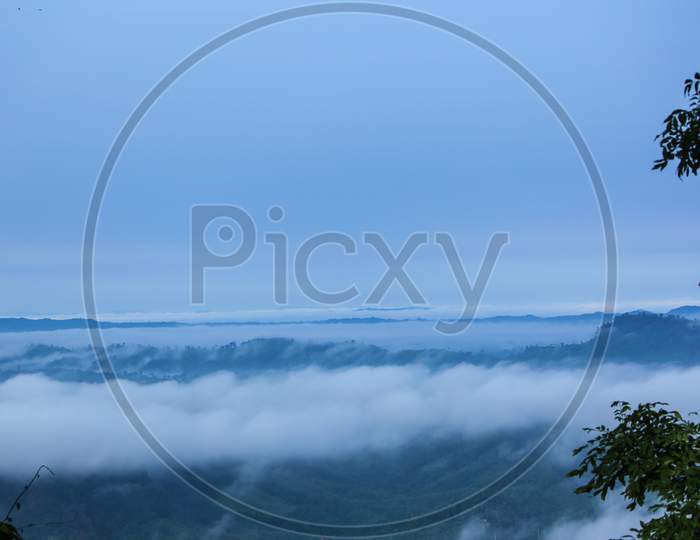 White clouds are floating over peak of the green hill in the morning  in Sajek Valley, Bangladesh