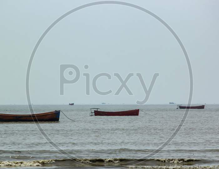 Three plastic fishing boats anchored  serially at harbor in chattrogram sea port, Bangladesh