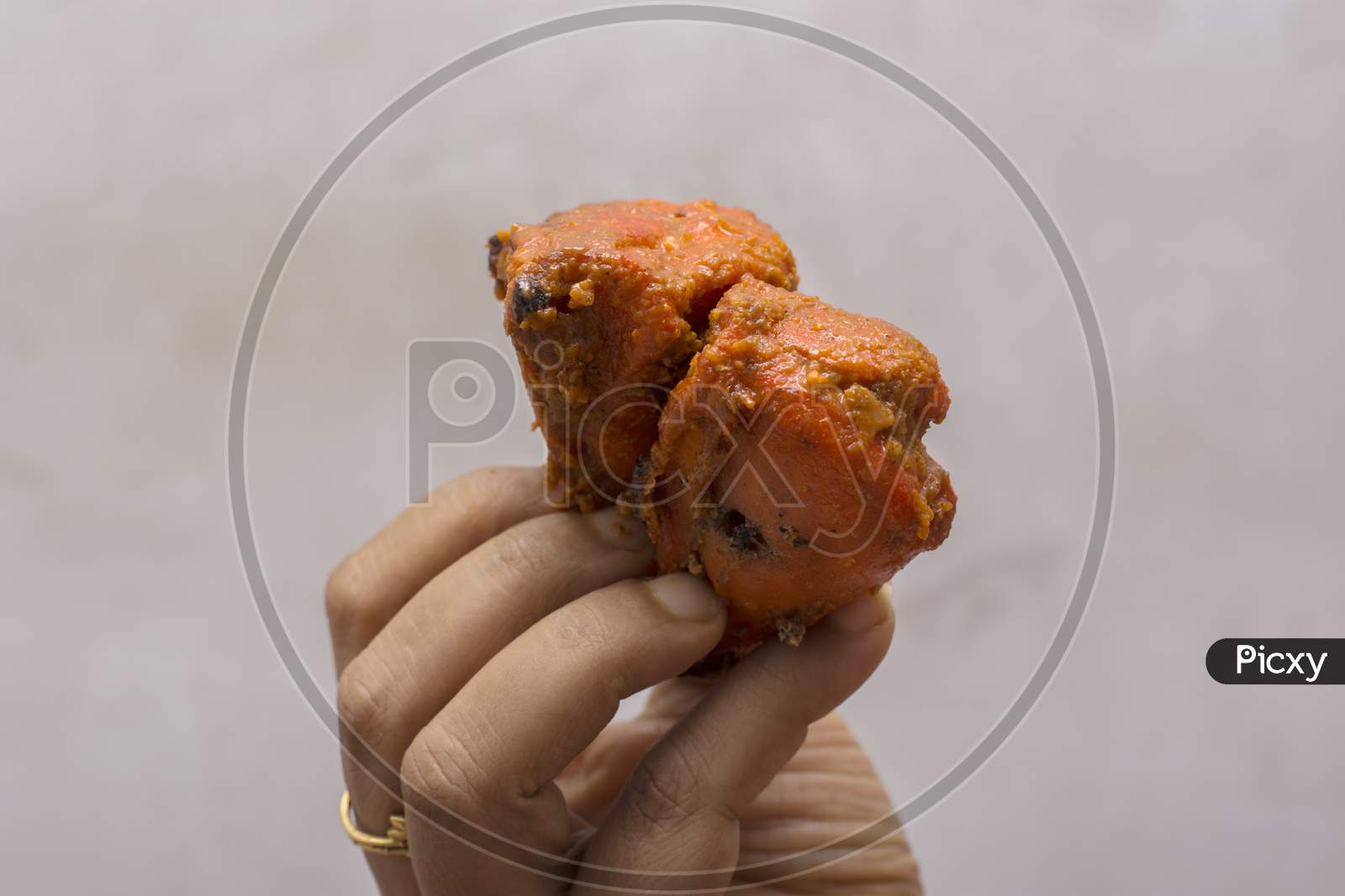 Delicious Juicy Grilled Chicken In A Female Hand With Selective Focus.