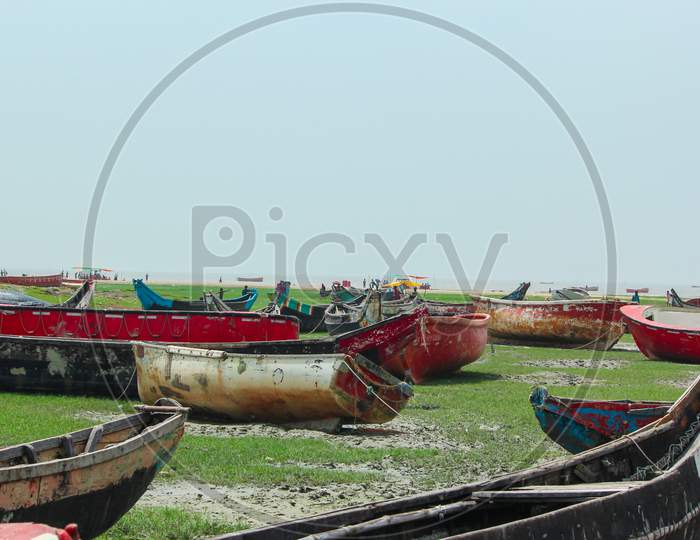 Lots of fishing boats anchored in surface of shore in Chattrogram sea beach, Bangldesh