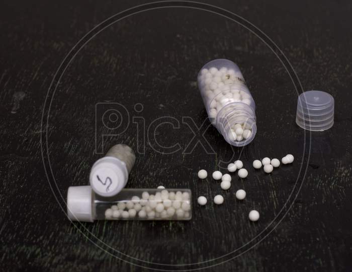 Homeopathic Medicines On A Black Background With Selective Focus