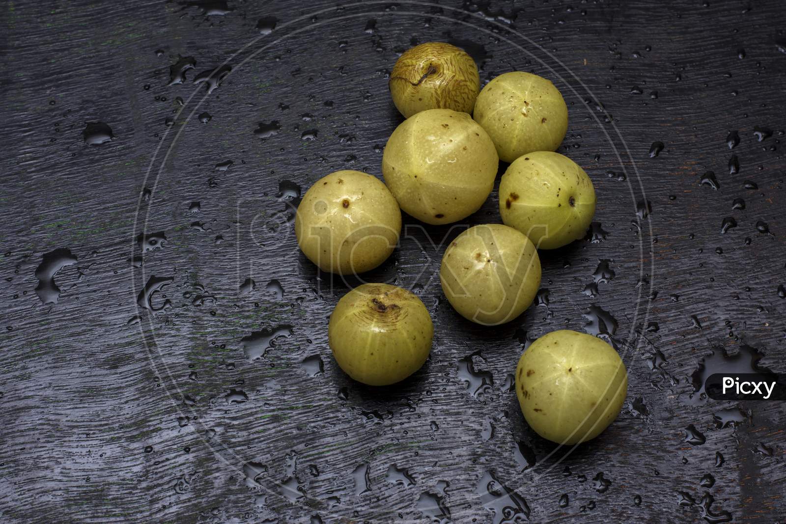 Few Fresh Organic Gooseberries On A Black Background With Selective Focus