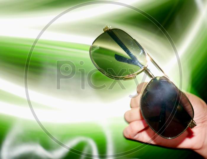 Black Shine Sunglasses Presented On Lady Hand With Light Effect Shine Backdrop, Commercial Product Presentation Image.