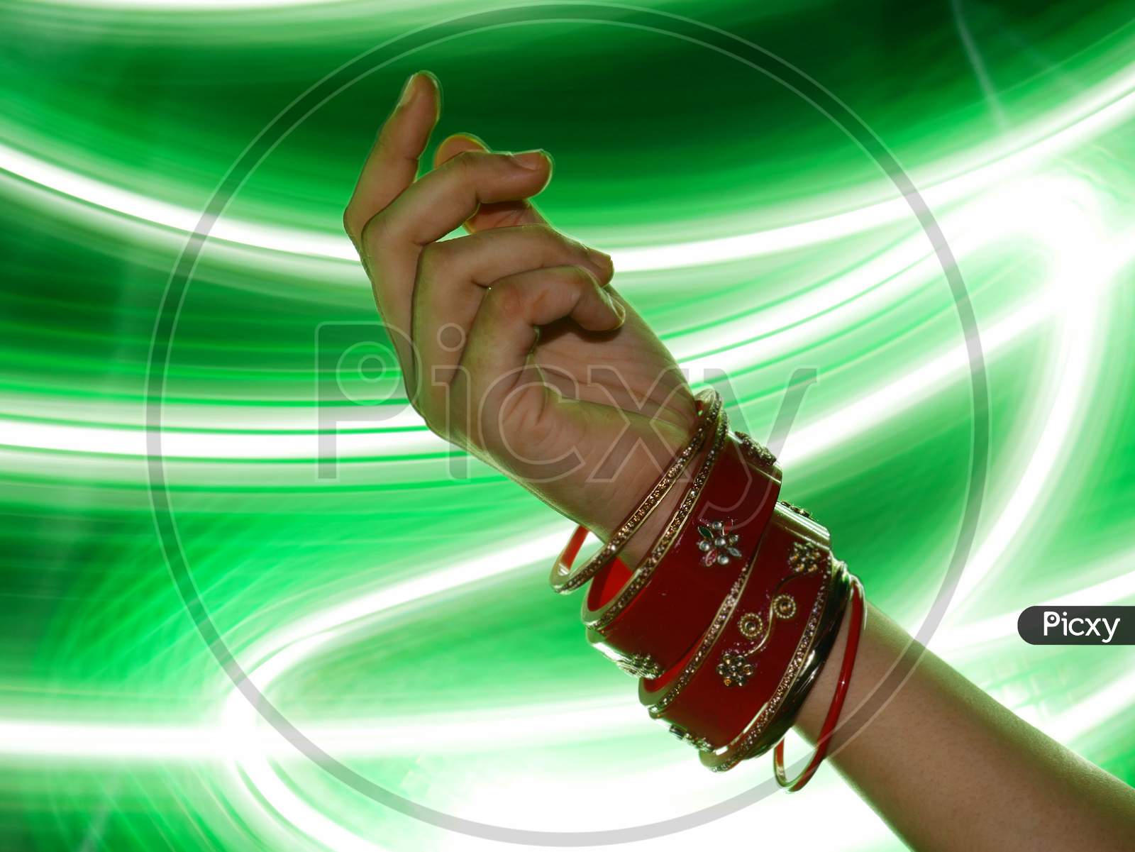 Indian Style Bangles Presented On Girl Hand With Light Effect Shine Backdrop, Commercial Fashion Product Presentation Image.