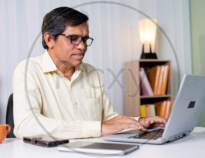 Businessman Smiling While Working Or Chatting On Laptop At Office - Concept Of Using Technology, Communication And Internet