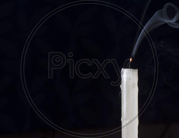 A Candle Without Light With Smoke Line In Dark. Concept Of Hopelessness And End Of Life With Selective Focus