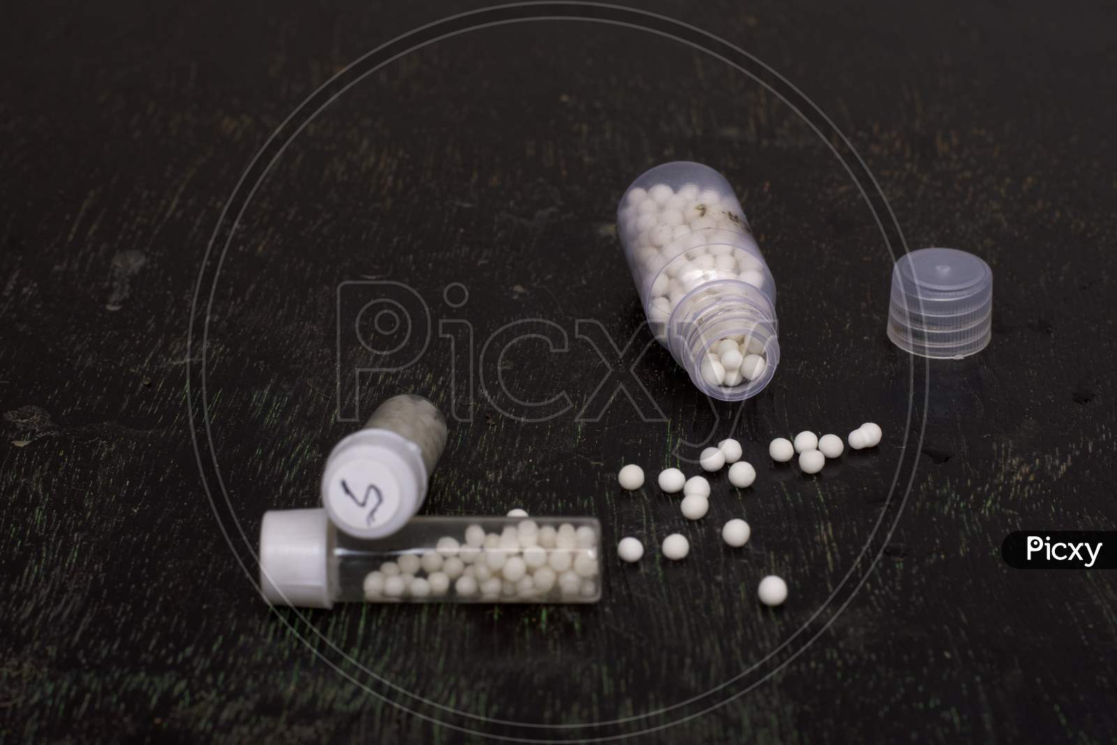 Homeopathic Medicines On A Black Background With Selective Focus