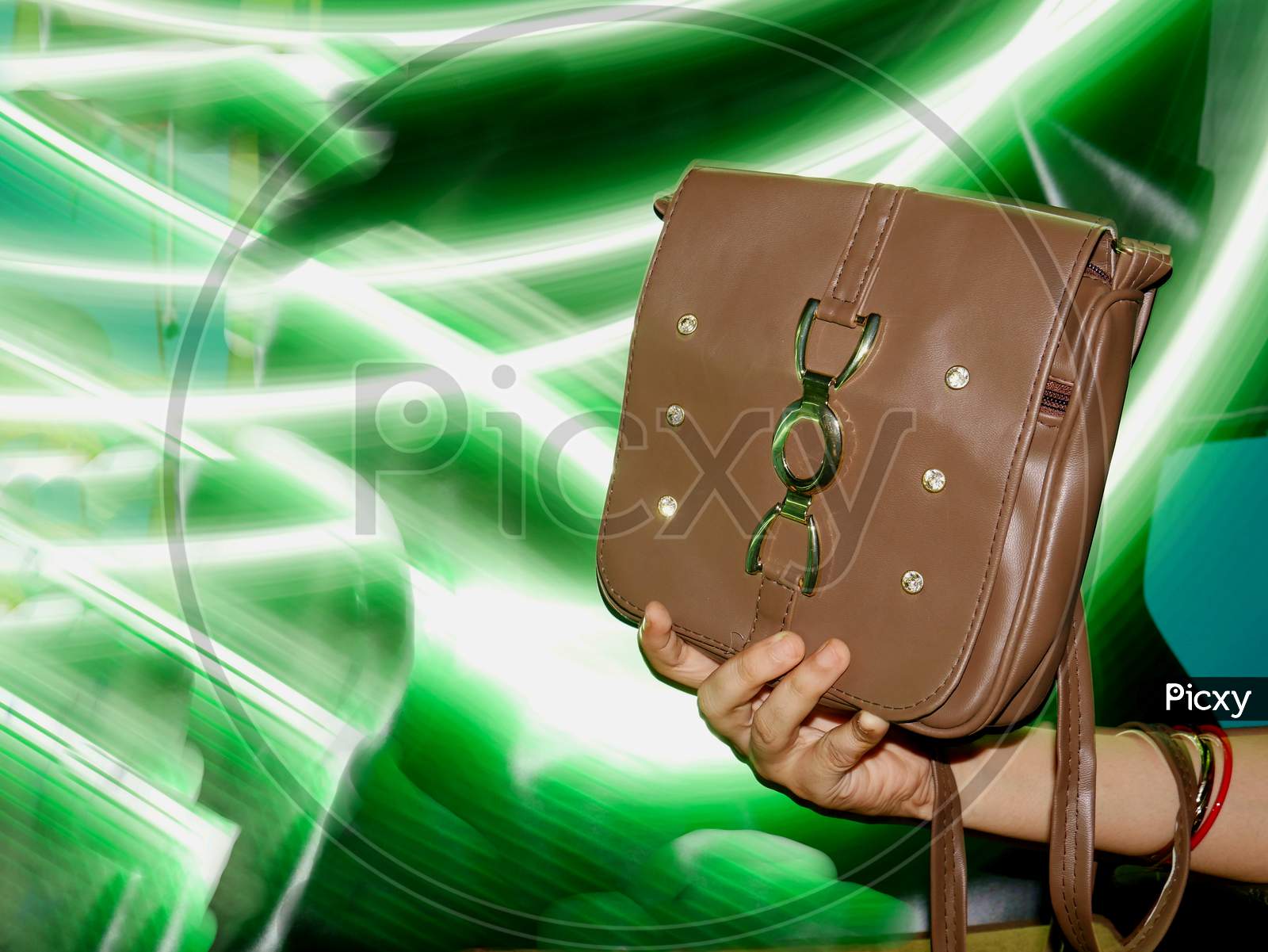 Woman Bag Presented On Girl Hand With Light Effect Shine Backdrop, Commercial Product Presentation Image.