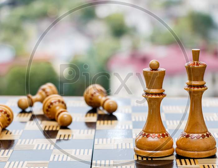Chessboard with figures on a blurred background