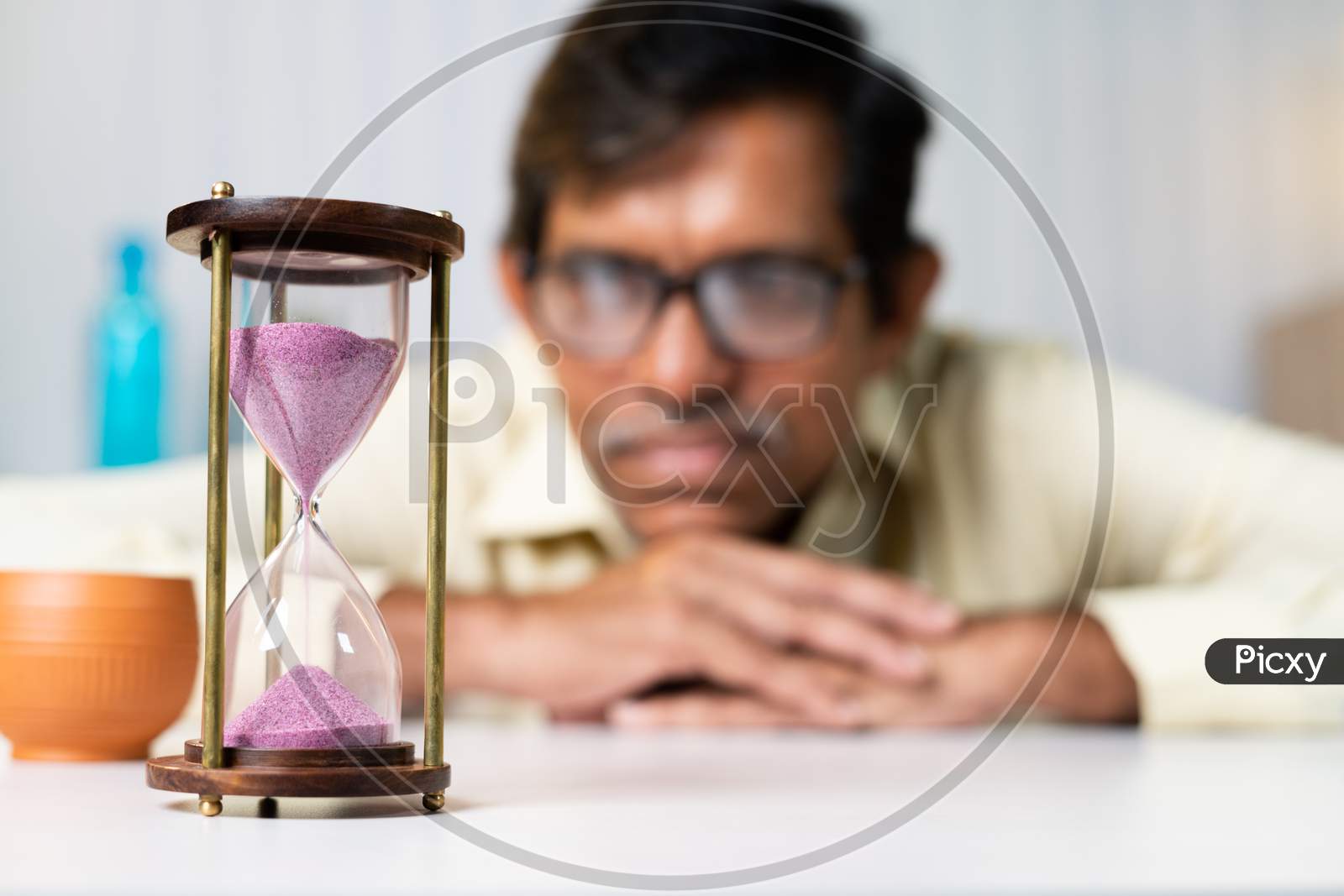 Focus On Hourglass, Businessman At Office Looking Hourglass - Concpet Of Time Management And Waitng For Good Time
