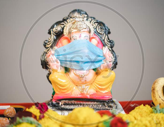 Ganesha Or Ganapati Idol With Medical Face Mask Kept For Festival Celebrations During Coronavirus Covid Pandemic To Encourage People To Wear Mask