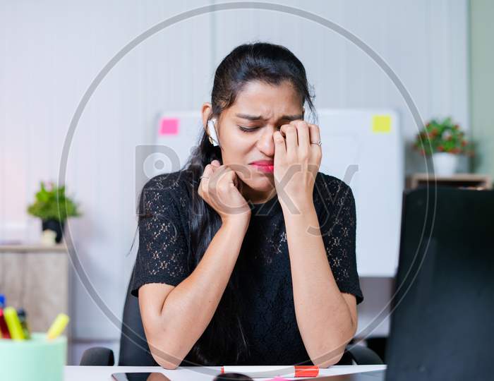 Medium Shot Of Frustrated Sad Crying Young Indian Woman At Work Place - Concept Of Emotional, Mental Or Work Stress At Office.