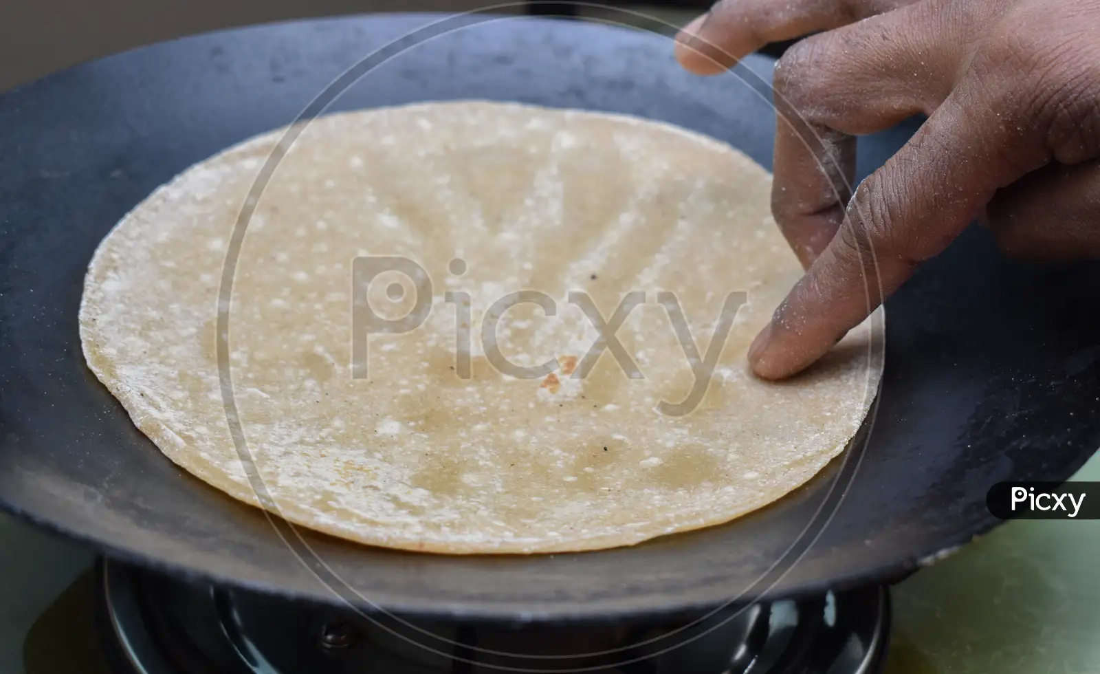 Image of Indian Soft Phulka Chapati (Roti) On Non Stick Tawa Also Known As  Tortilla.-CB807938-Picxy