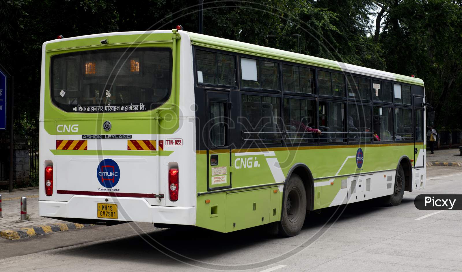 Cng Fueled City Bus Halting At A Bus Stop To Allow Passengers To Alight And Climb Abroad.