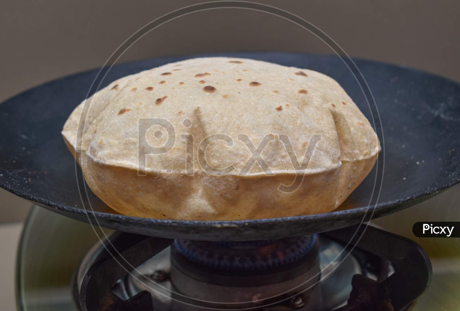 Image of Indian Soft Phulka Chapati (Roti) On Non Stick Tawa Also