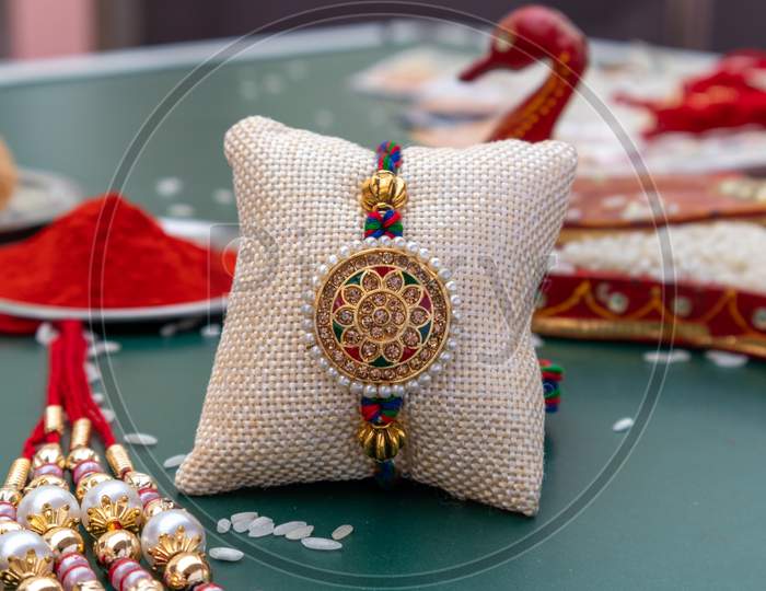 Indian Festival: A Bunch Of Rakhi On Rakshabandhan Decorated With Kumkum And Rice With Sweets|A Traditional Wrist String That Celebrates The Special Bond Between Brother And Sisters
