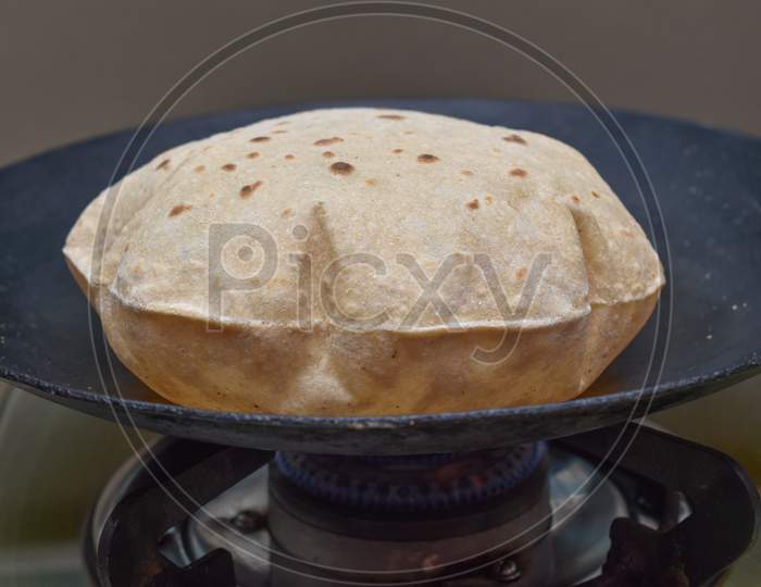 Indian Soft Phulka Chapati (Roti) On Non Stick Tawa Also Known As Tortilla.