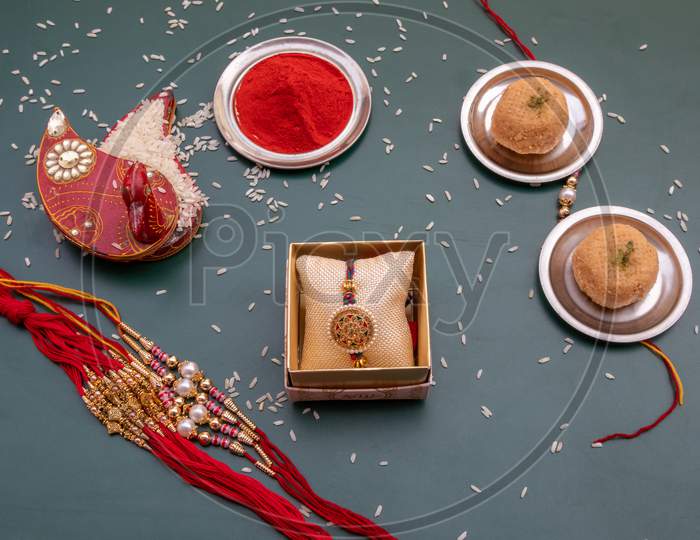 Indian Festival: A Bunch Of Rakhi On Rakshabandhan Decorated With Kumkum And Rice With Sweets|A Traditional Wrist String That Celebrates The Special Bond Between Brother And Sisters