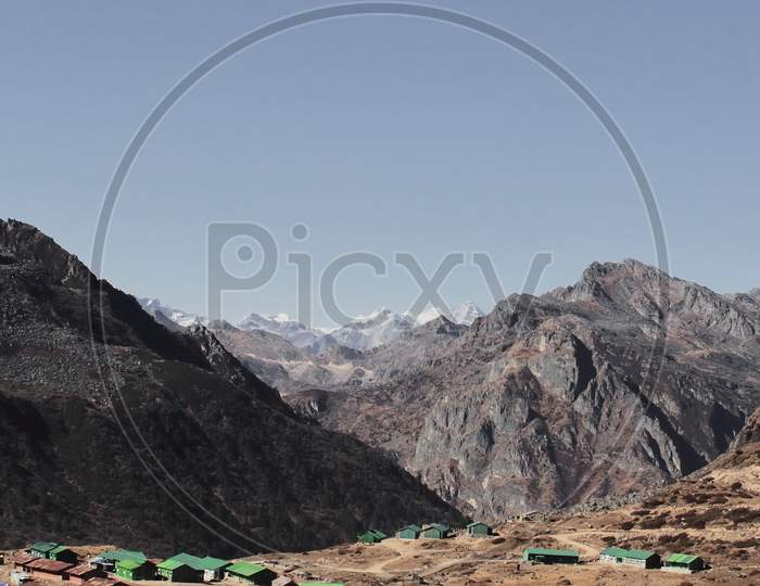 scenic mountain village with arid alpine landscape and snow capped gori chen peak near bum la pass in tawang district of arunachal pradesh, north east india