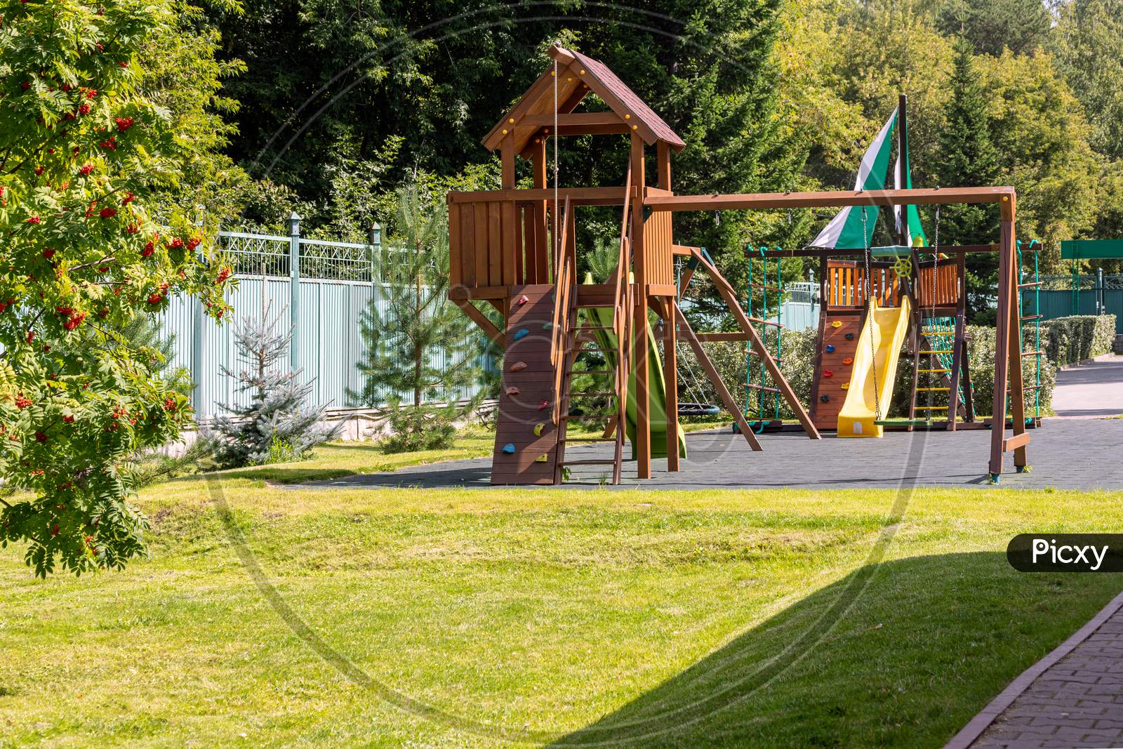 Empty Playground For Children For Leisure And Recreation With A Toy In The Park As A Child In A Natural Style. Playground In A Swing For Mom And Baby