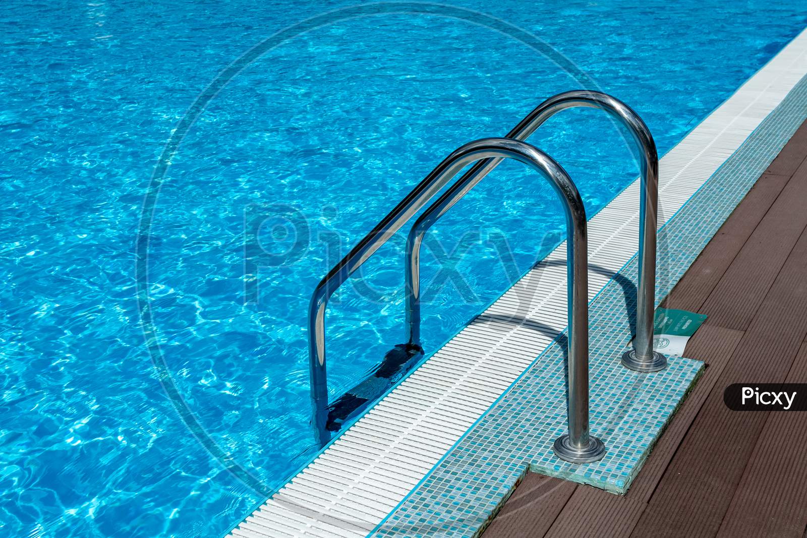 Handrail On Pool. Swimming Pool With Stair At Tropical Resort. Water Swimming Pool With Sunny Reflection. Steel Handrail, Swimming, Summer, Travel. Entry To Pool With Handrail.
