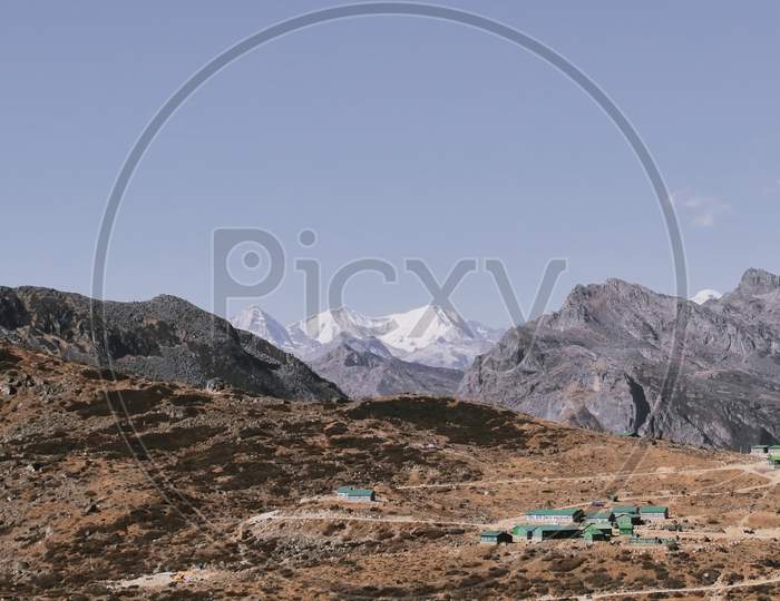 scenic mountain village with arid alpine landscape and snow capped gori chen peak near bum la pass in tawang district of arunachal pradesh, north east india