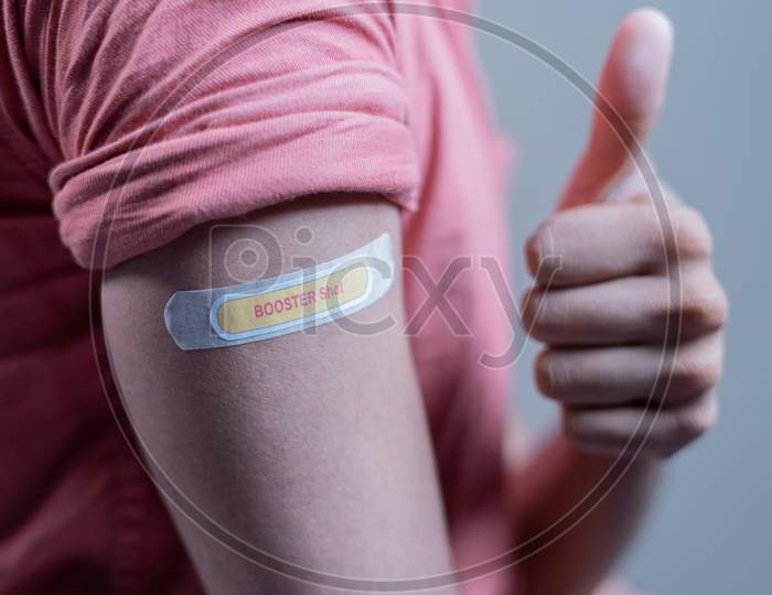 Covid-19 Or Coronavirus Vaccinated Shoulder With Booster Shot Sticker And Thumbs Up Gesture - Concept Of Approved Coronavirus 3Rd Dose Vaccination For Immunocompromised.