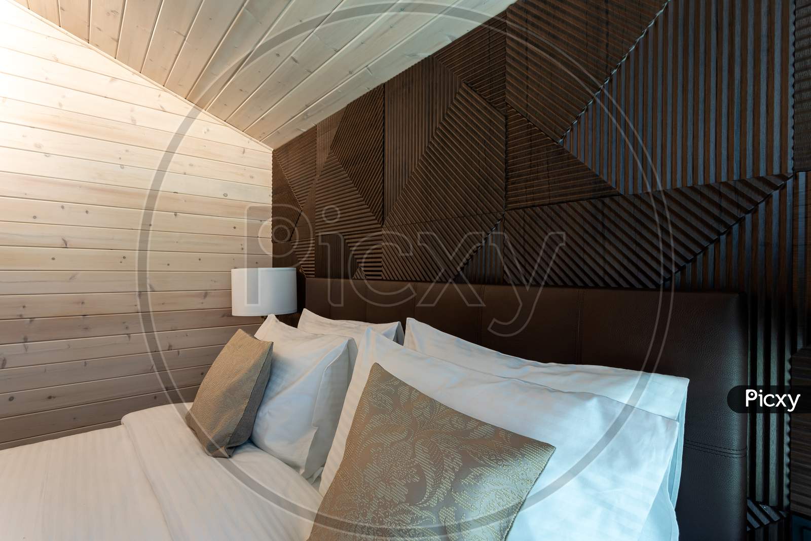 White Bed,  Quilt And Pillows In  Wooden Bedroom.  Hotel Bedroom.  Comfortable Bed With Soft Blanket In Stylish Room