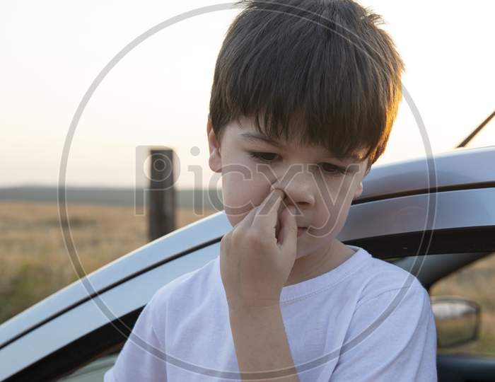 Boy Picking His Nose Next To A Car.