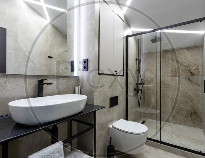 Bathroom In A Traditional Style With Brown And Gray Walls.Minimalist Shower Room With Hotel Sauna