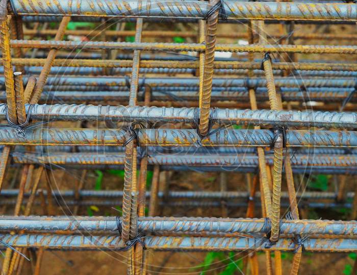 Rusty Metal Wiring Is Laid On The Ground Of House Under Construction. Preparation For Making Foundation Of A Building.