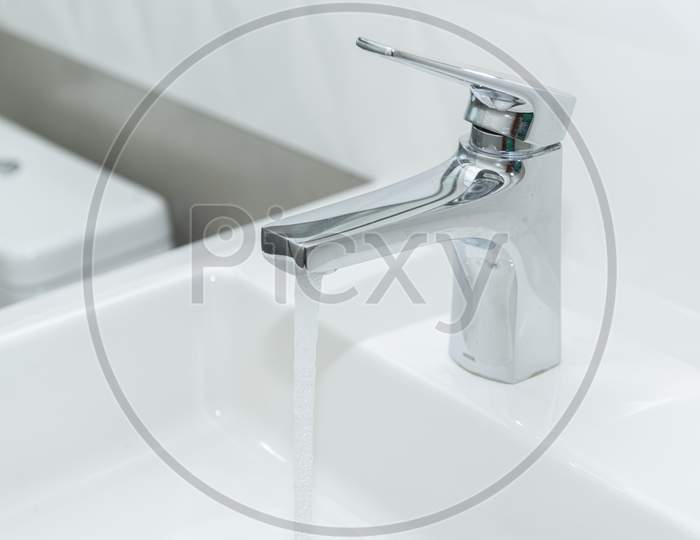 White Marble Sink With Modern Overlay Basin And Shiny Stainless Steel Faucet