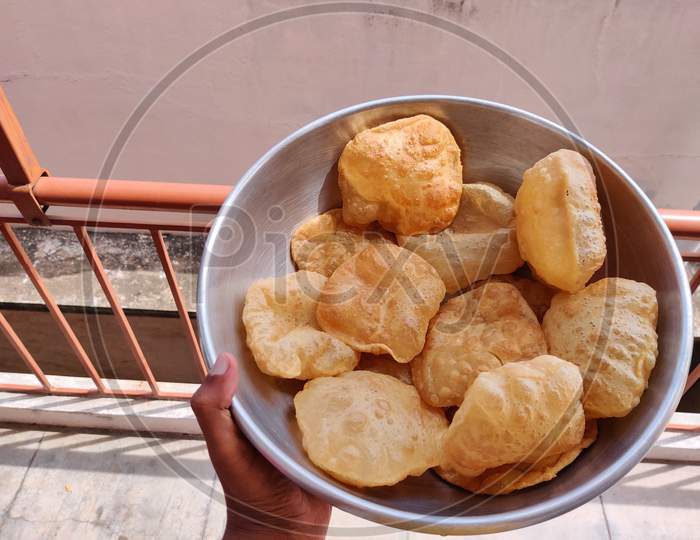 Indian Tradtitonal Food. Hand Holding A Bowl Full Of Poori Or Puri.
