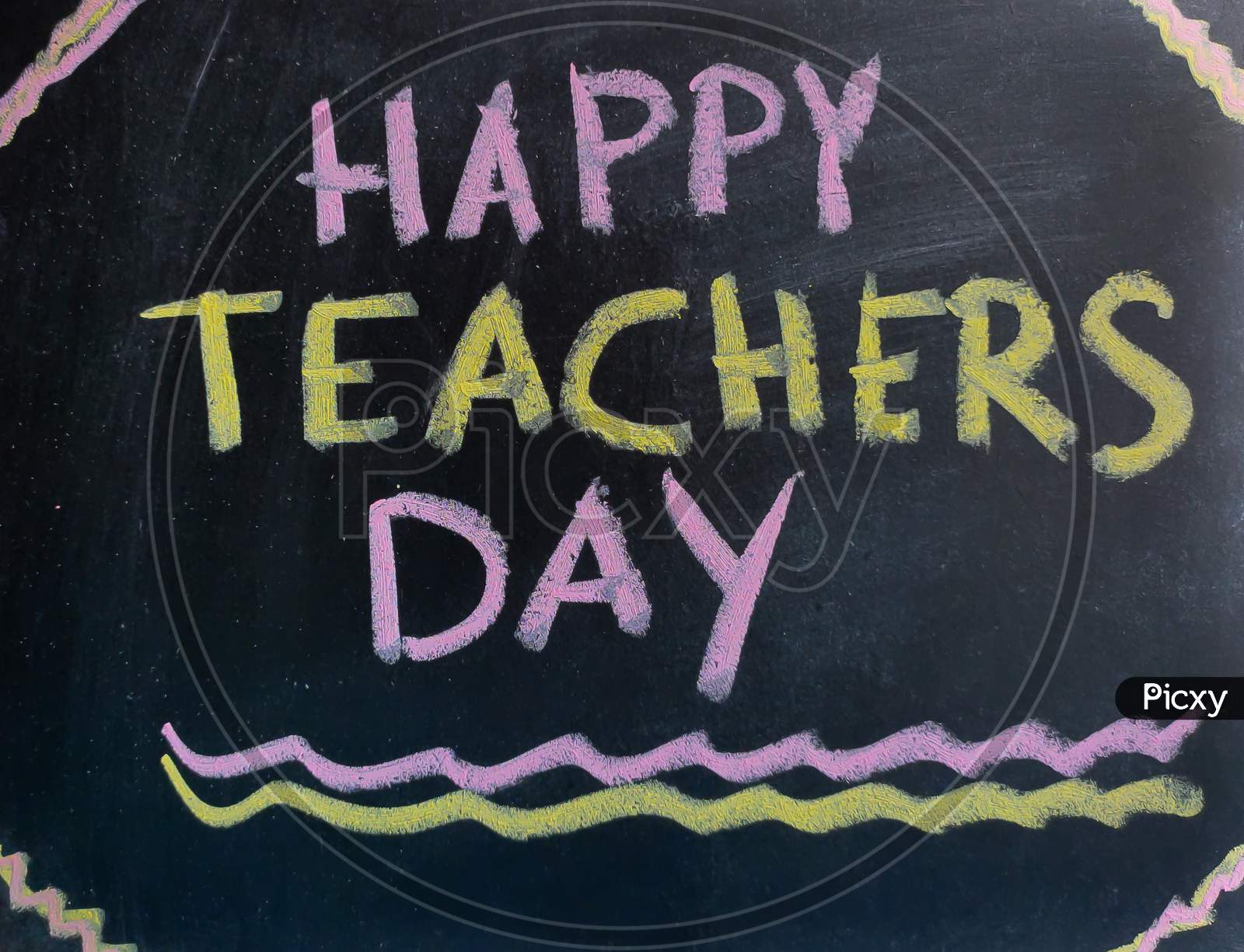 Happy Teachers Day Written With Colorful Chalk On Slate Or Black Board For 5Th September.
