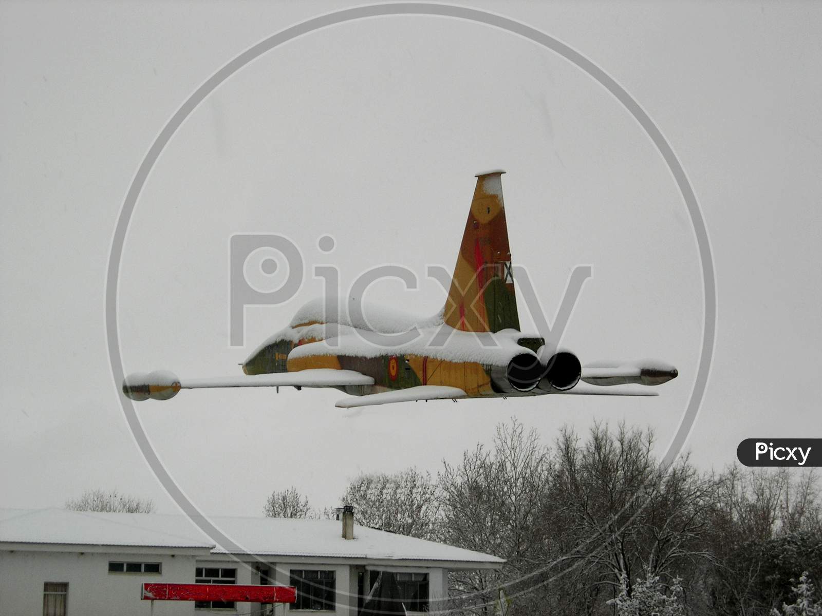 War Plane Flying On A Snowy Day