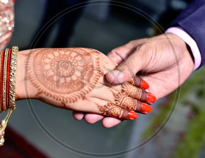 Closup Of Indian Young Adult Male Groom And Female Bride Holding Hands