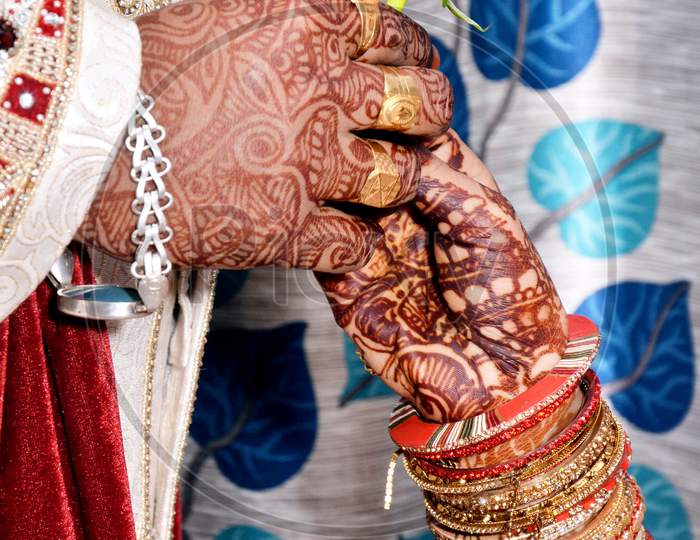 Closeup Of An Indian Groom Giving A Rose Flower To A Bride During Wedding Ceremony