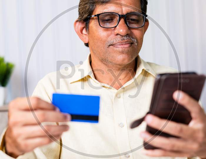 Officer Or Businessman Using Credit Card For Payment While Purchasing Or Paying Bills - Concept Of E-Commerce, Secure Online Payments From Mobile Phone Or Smartphone.